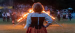 A participant in the Torchlight Ceremony viewing the Saltire Cross during the Grandfather Mountain Highland Games at MacRae Meadows on July 9, 2026