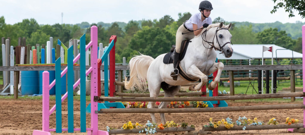 Rider clearing a jump at a TTC Jumper show